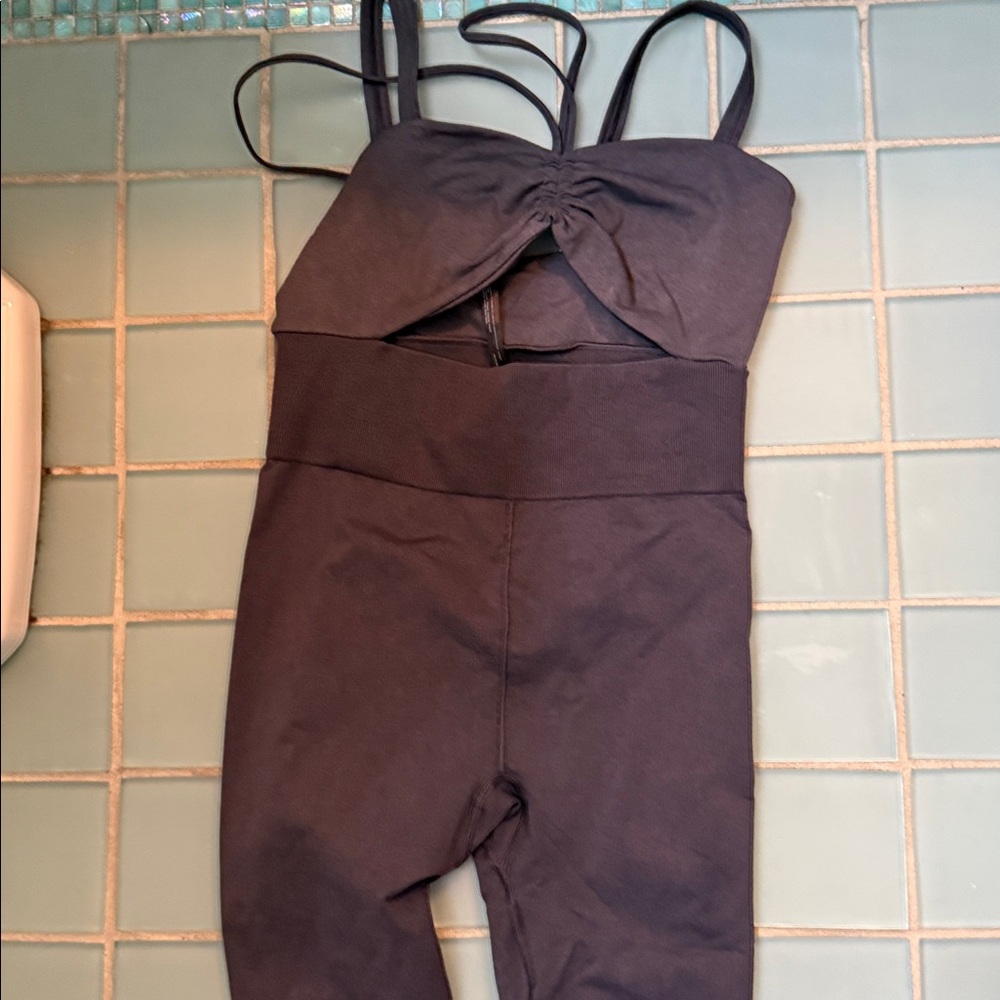 New without tags — Free People Movement Good Karma Cut Out Onesie Washed Black.
